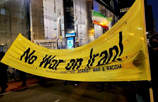Photo from protest
Large yellow banner with large black text saying: 
No War On Iran!